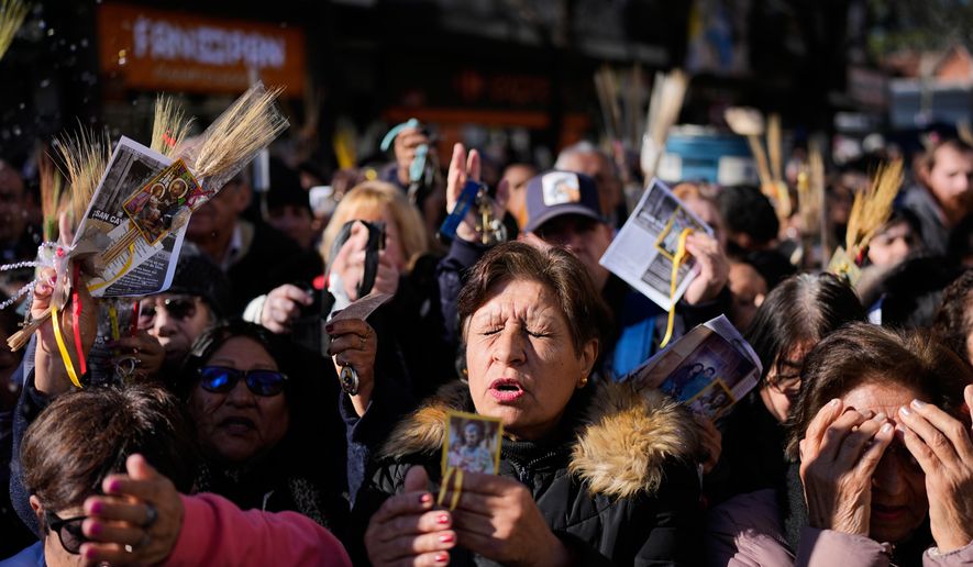 Pilgrims attend an outdoor Mass outside the Church of San Cayetano during the annual pilgrimage honoring Saint Cajetan, the patron saint of work, in Buenos Aires, Argentina, Friday, Aug. 7, 2026. (AP Photo/Natacha Pisarenko)
