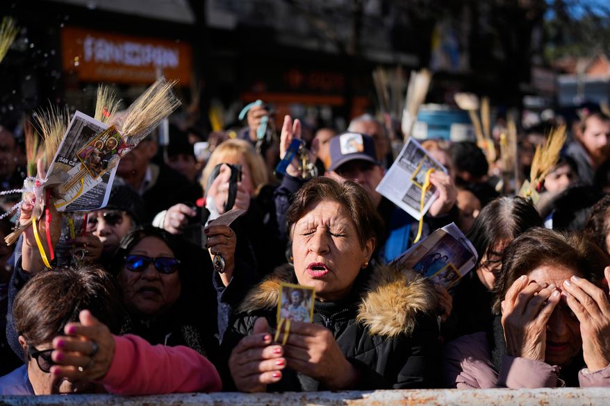 Pilgrims attend an outdoor Mass outside the Church of San Cayetano during the annual pilgrimage honoring Saint Cajetan, the patron saint of work, in Buenos Aires, Argentina, Friday, Aug. 7, 2026. (AP Photo/Natacha Pisarenko)