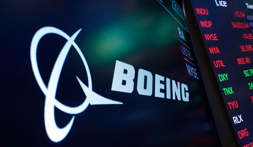 The logo for Boeing appears on a screen above a trading post on the floor of the New York Stock Exchange, July 13, 2021. (AP Photo/Richard Drew, File)
