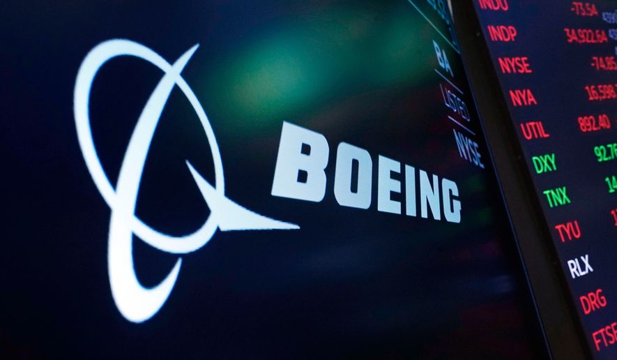 FILE - The logo for Boeing appears on a screen above a trading post on the floor of the New York Stock Exchange, July 13, 2021. (AP Photo/Richard Drew, File)