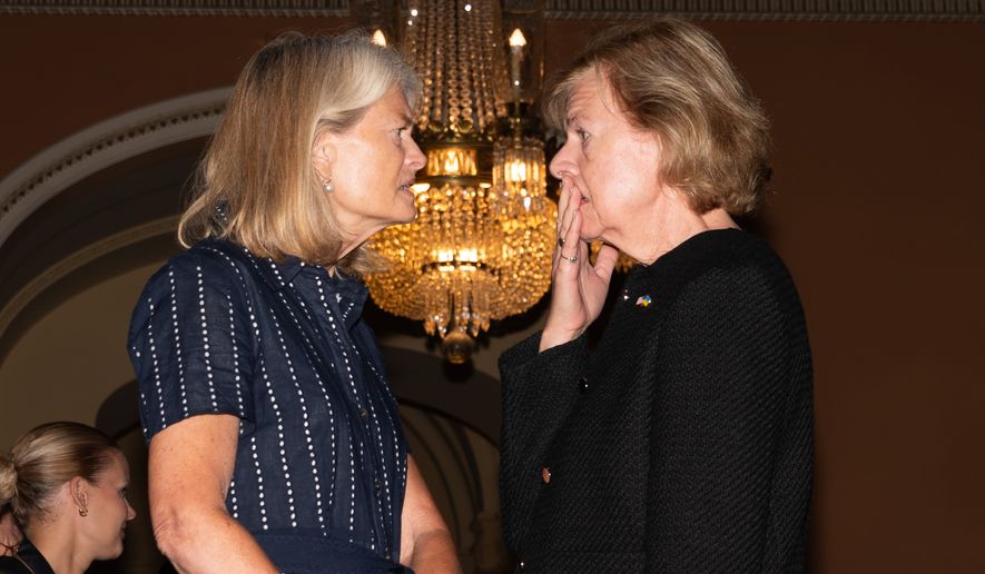 Sen. Lisa Murkowski, R-Alaksa, talks with Sen. Tammy Baldwin, D-Wis., at the U.S. Capitol, Tuesday, July 28, 2026, in Washington. (AP Photo/Allison Robbert)