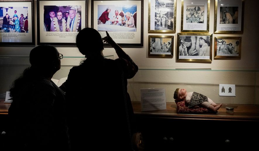 Visitors view photos displayed inside a museum showcasing Cochin's Jewish history next to the 458-year-old Paradesi Synagogue in the historic Jew Town neighborhood of Kochi, India, Wednesday, May 20, 2026. (AP Photo/Aijaz Rahi)