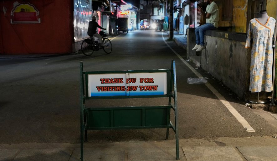 An iron stand with a message at the entrance to the historic Jew Town neighborhood of Kochi, India, Wednesday, May 20, 2026. (AP Photo/Aijaz Rahi)
