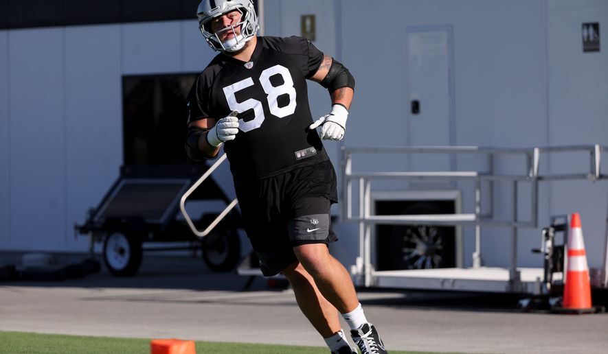 Las Vegas Raiders guard Jackson Powers-Johnson (58) participates in a drill during practice at the team's NFL football training camp, Thursday, July 30, 2026, in Henderson, Nev. (AP Photo/Ian Maule)