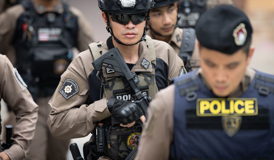 Police officers secure Debsirin Nonthaburi School, where a shooting killed several people in Thailand's Nonthaburi province, Friday, Aug. 7, 2026. (AP Photo/Wason Wanichakorn)