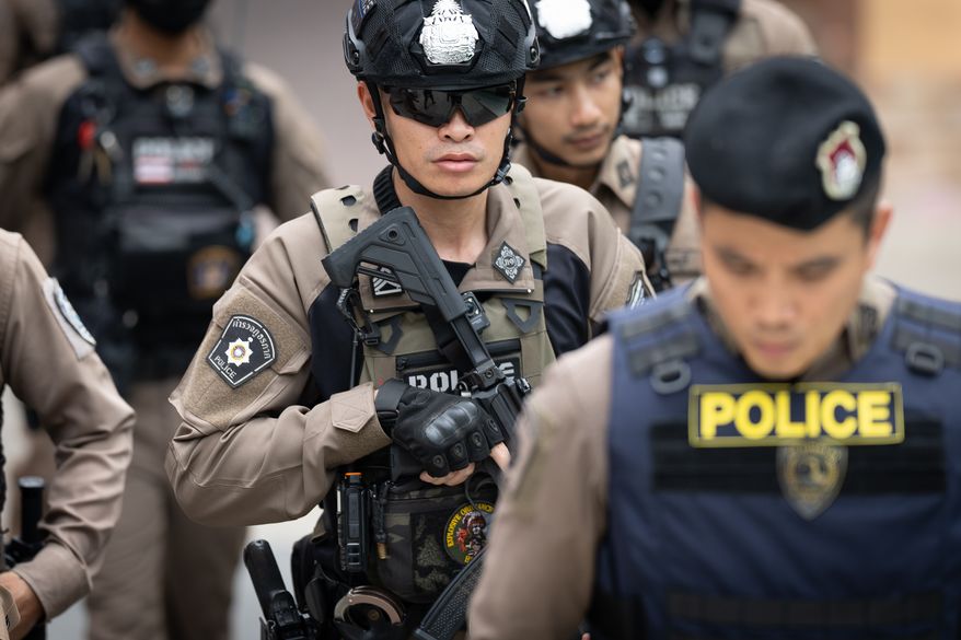 Police officers secure Debsirin Nonthaburi School, where a shooting killed several people in Thailand's Nonthaburi province, Friday, Aug. 7, 2026. (AP Photo/Wason Wanichakorn)