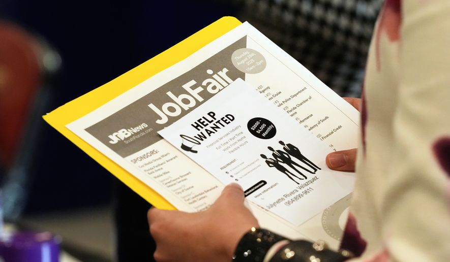 A job seeker waits to talk to a recruiter at a job fair Aug. 28, 2025, in Sunrise, Fla. (AP Photo/Marta Lavandier, File)