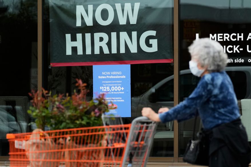 A hiring sign for sales professionals is displayed at a store in Vernon Hills, Ill., Wednesday, April 15, 2026. (AP Photo/Nam Y. Huh, file)