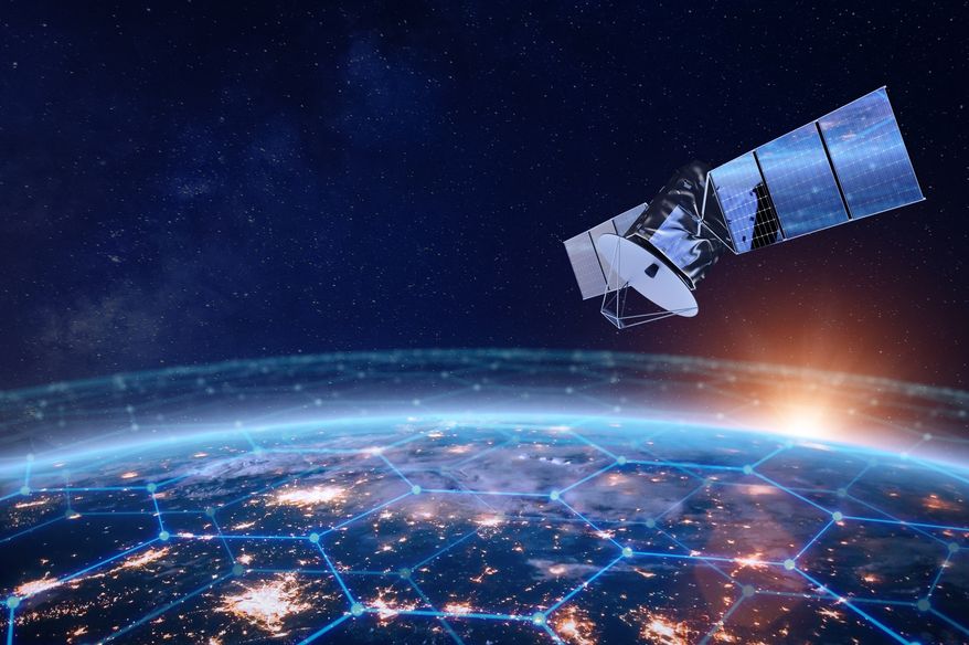 Telecommunication satellite providing global internet network and high speed data communication above Europe. Satellite in space, low Earth orbit. Worldwide data communication technology. Image credit: NicoElNino via Shutterstock.