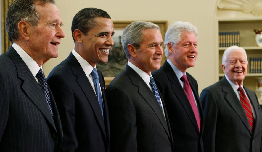 FILE - President George W. Bush, center, poses with President-elect Barack Obama, and former presidents, from left, George H.W. Bush, left, Bill Clinton and Jimmy Carter, right, Jan. 7, 2009, in the Oval Office of the White House in Washington. (AP Photo/J. Scott Applewhite, File)