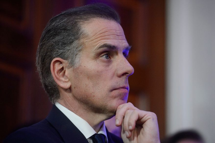 Hunter Biden listens while his father, President Joe Biden, speaks during a Hanukkah reception in the East Room of the White House in Washington, Dec. 16, 2024. (AP Photo/Rod Lamkey, Jr., File)