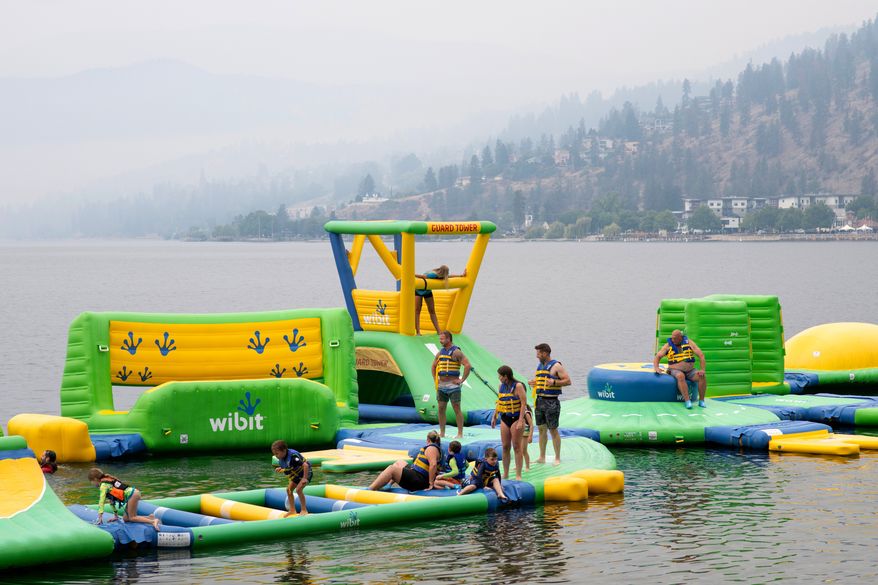 People play at the Peachland Water Park in Peachland, British Columbia, Canada, on Saturday, Aug. 8, 2026. (Gary Nylander/The Canadian Press via AP)