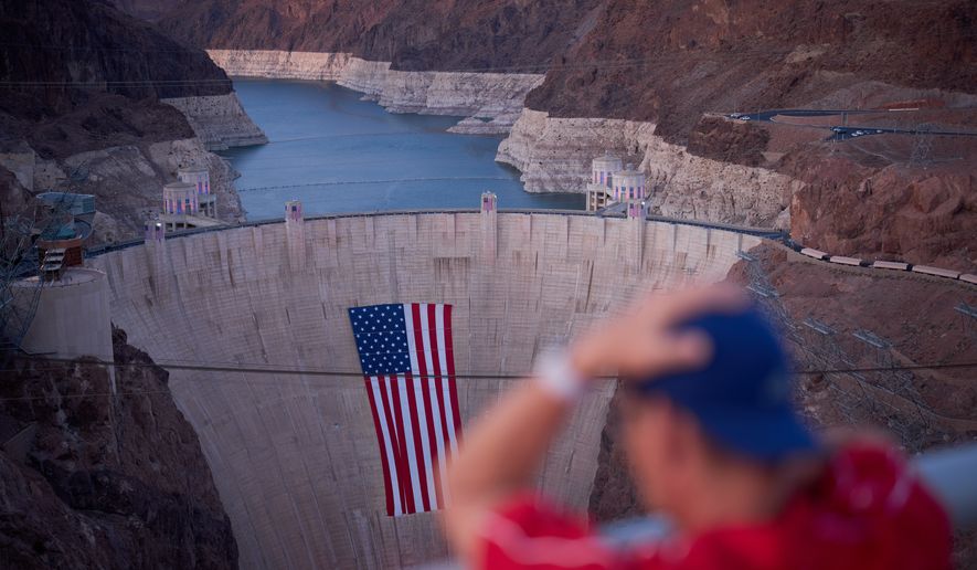 A bathtub ring of light minerals shows the high water line of Lake Mead near the Hoover Dam at the Lake Mead National Recreation Area Tuesday, June 30, 2026, near Boulder City, Nev. (AP Photo/John Locher)
