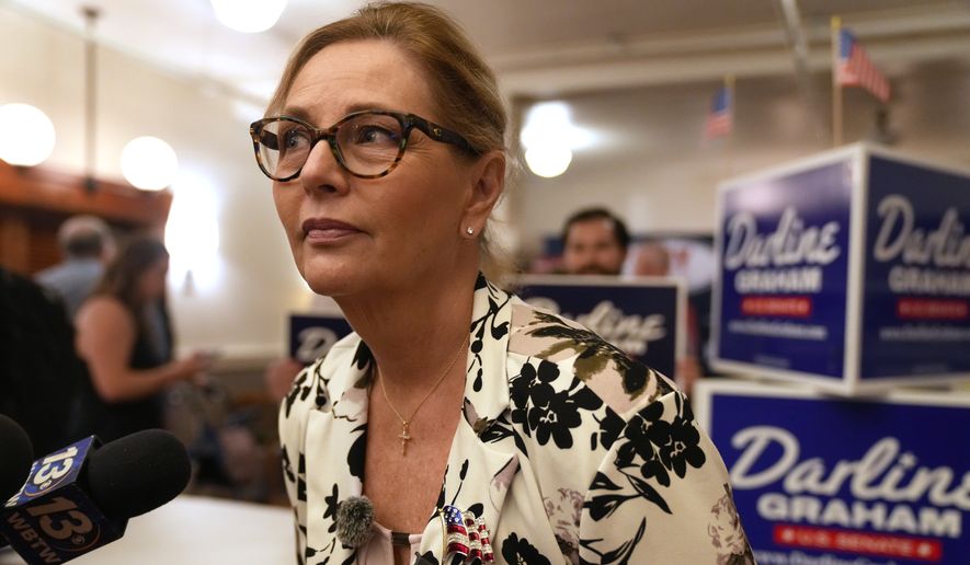 Sen. Darline Graham, R-S.C., leans over to hear a reporter's question following at a candidate event for hopefuls vying in a special Republican primary to replace her late brother Sen. Lindsey Graham, R-S.C., on November ballots, Saturday, Aug. 8, 2026, in Florence, S.C. (AP Photo/Meg Kinnard)