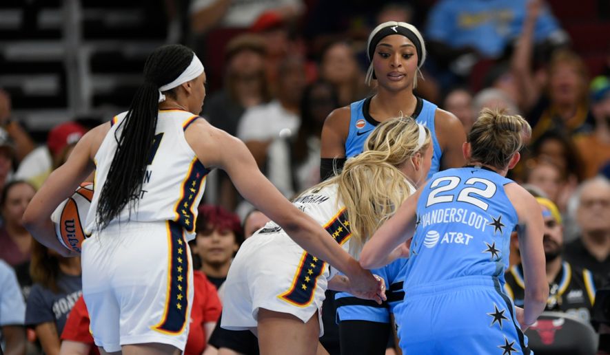 Chicago Sky's DiJonai Carrington, back, stares down Indiana Fever's Sophie Cunningham (8) after committing a flagrant foul against Cunningham and before she was ejected from the game during the first half of an WNBA basketball game in Chicago, Saturday, Aug. 8, 2026. (AP Photo/Paul Beaty)