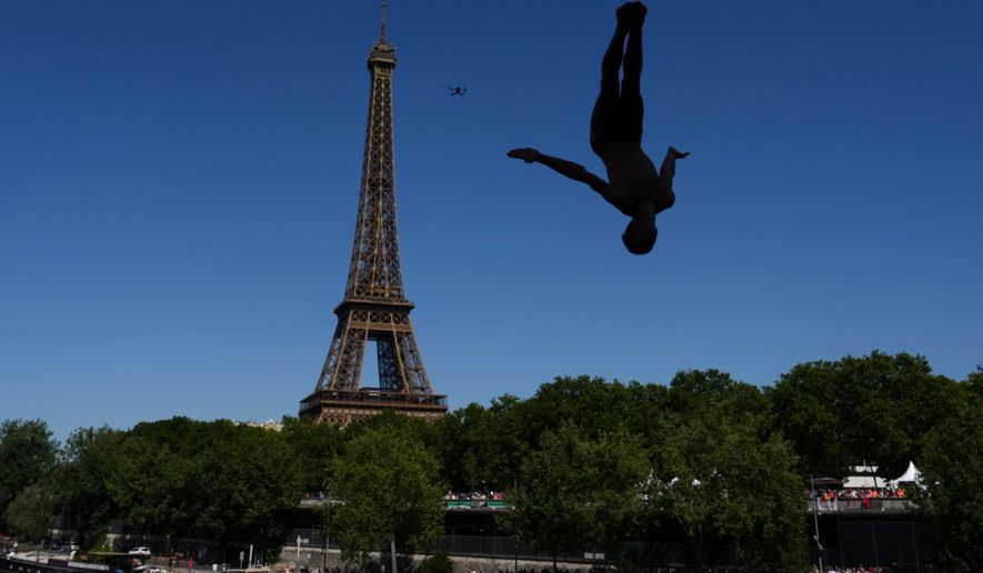 Italy's Andrea Barnaba competes in front of the Eiffel Tower during round 1 of the men's 20m Platform high diving at the European Aquatics Championships in Paris, Friday, Aug. 7, 2026. (AP Photo/Aurelien Morissard)