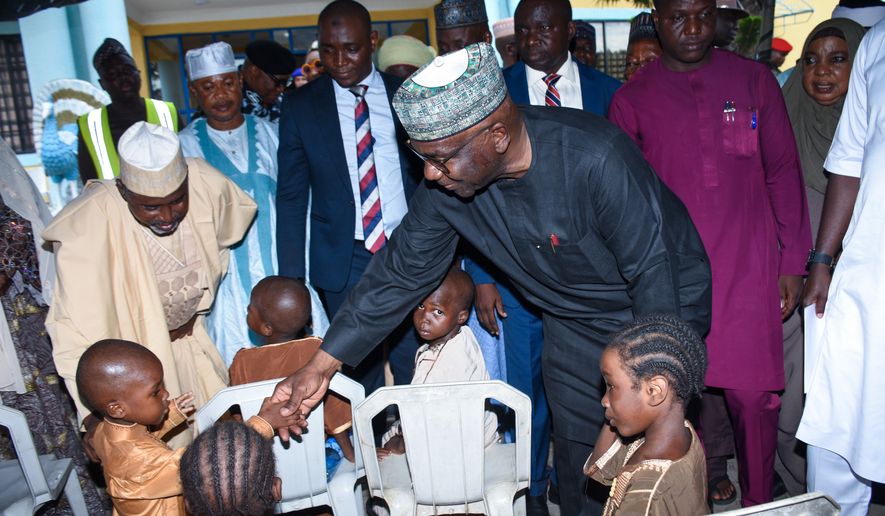 Kwara state Gov. Abdulrahman Abdulrazaq greets children at a hotel in Ilorin, Nigeria, Friday, Aug. 7, 2026, where they are staying after being rescued from a forest where they were held following their abduction from the Woro community by gunmen in February. (AP Photo/Abubakar Khadijat)