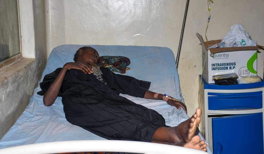 A woman who was rescued after being held in a forest after being abducted from the Woro community by gunmen in February receives medical attention at a hospital in Ilorin, Nigeria, Friday, Aug. 7, 2026. (AP Photo/Abubakar Khadijat)