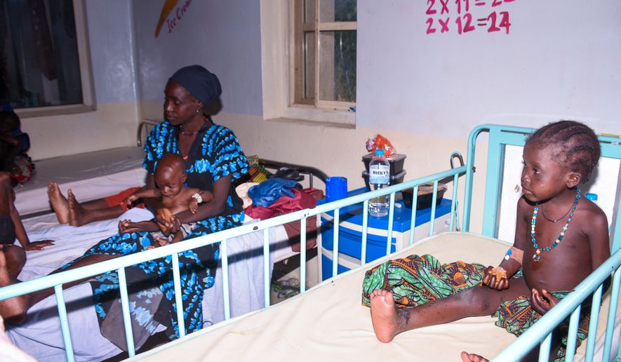 Women and children who were rescued after being held in a forest after they were abducted from the Woro community by gunmen in February receive medical attention at a hospital in Ilorin, Nigeria, Friday, Aug. 7, 2026. (AP Photo/Abubakar Khadijat)
