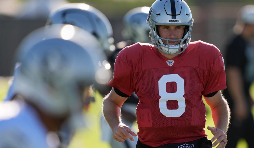 Las Vegas Raiders quarterback Kirk Cousins (8) warms up during practice at the team's NFL football training camp Tuesday, Aug. 4, 2026, in Henderson, Nev. (AP Photo/John Locher)