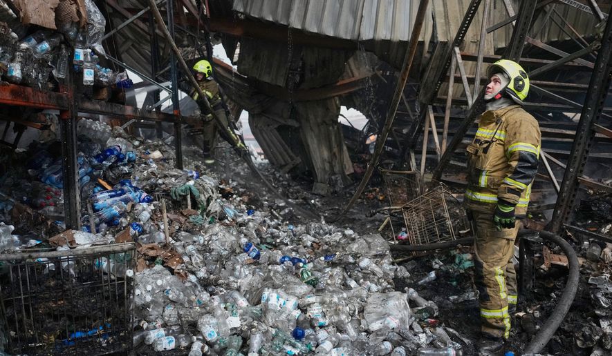 Firefighters work at the site of a fire after Russian missiles hit a food warehouse near Kyiv, Ukraine, Wednesday, Aug. 5, 2026. (AP Photo/Efrem Lukatsky)