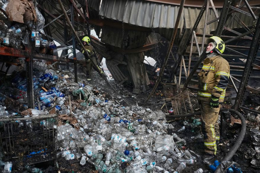 Firefighters work at the site of a fire after Russian missiles hit a food warehouse near Kyiv, Ukraine, Wednesday, Aug. 5, 2026. (AP Photo/Efrem Lukatsky)