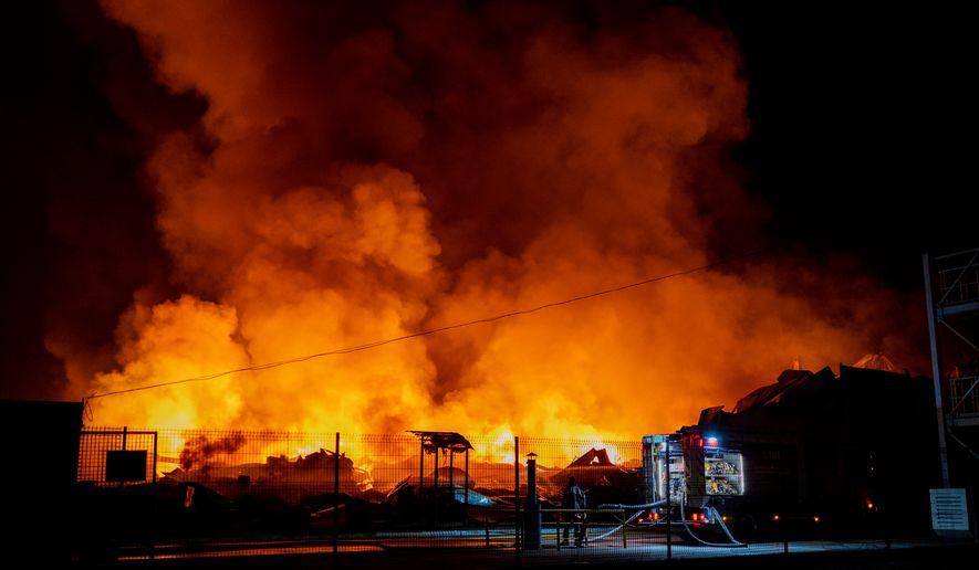 Firefighters put out a fire after Russian missiles hit a warehouse in Kyiv, Ukraine, Wednesday, Aug. 5, 2026. (AP Photo/Dan Bashakov)