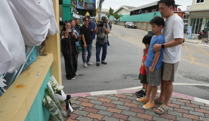 People offer prayers at the gate of Debsirin Nonthaburi School, a day after the shooting at the school in Nonthaburi province, Thailand, Saturday, Aug. 8, 2026. (AP Photo/Sakchai Lalit)