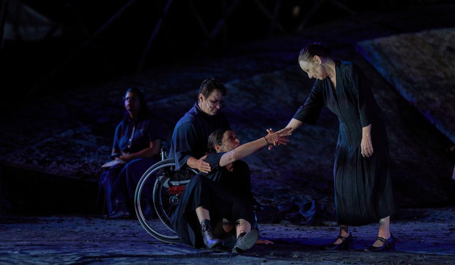 From left to right, Eirini Kourouvani, a wheelchair dancer, Evi Saoulidou and Lydia Fotopoulou perform during a dress rehearsal of Euripides' tragedy The Trojan Women, staged by the National Theatre of Greece, at the Ancient Theater of Epidaurus, Greece, on Thursday, July 30, 2026. (AP Photo/Petros Giannakouris)