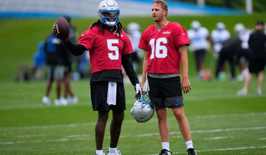 Detroit Lions quarterbacks Teddy Bridgewater (5) talks with Jared Goff (16) during practice at the NFL football team's training camp, in Allen Park, Mich., Sunday, Aug. 2, 2026. (AP Photo/Paul Sancya)