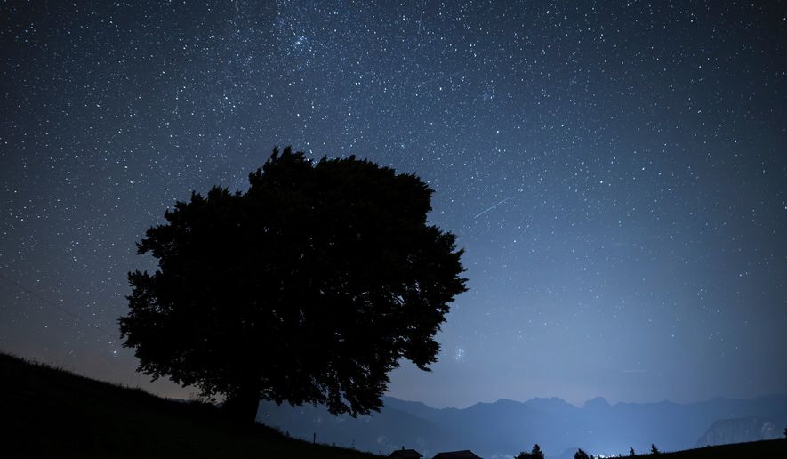 FILE - Stars and shooting stars are pictured during the annual perseids meteor shower in St. Margrethenberg, Switzerland Monday, Aug. 12, 2024. (Gian Ehrenzeller/Keystone via AP,File)