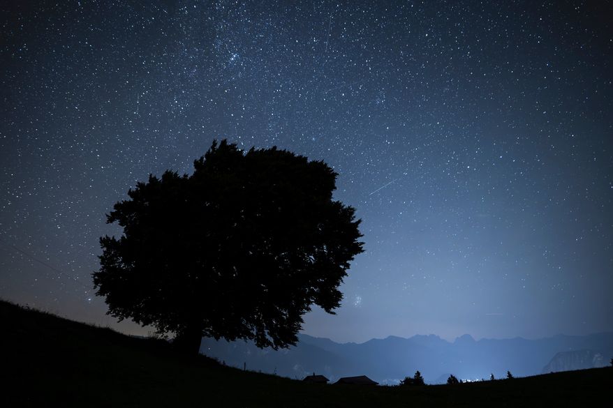 FILE - Stars and shooting stars are pictured during the annual perseids meteor shower in St. Margrethenberg, Switzerland Monday, Aug. 12, 2024. (Gian Ehrenzeller/Keystone via AP,File)