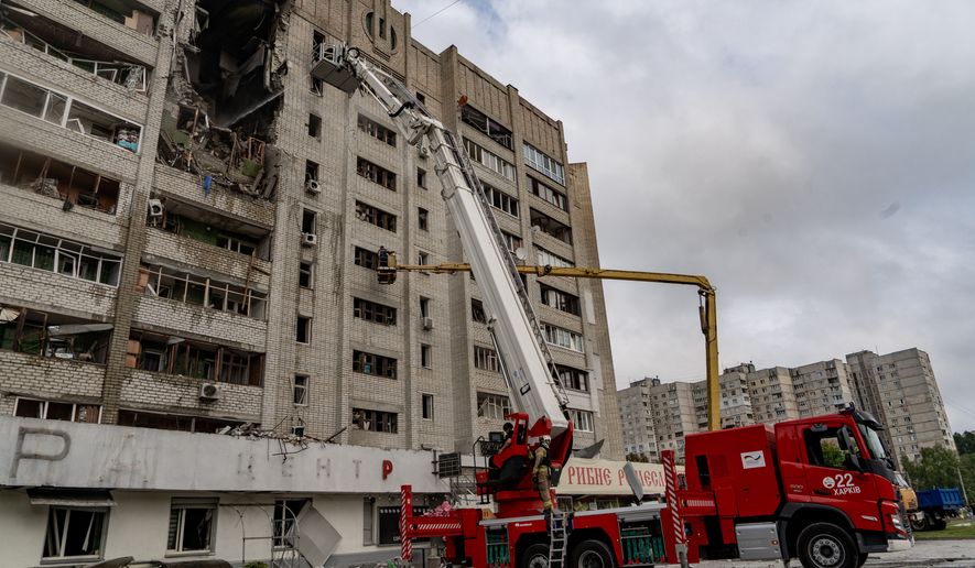 Firefighters put out a fire after a residential building was hit following Russia's drone attack in Kharkiv, Ukraine, Sunday, Aug. 9, 2026. (AP Photo/Andrii Marienko)