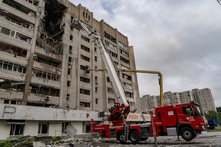 Firefighters put out a fire after a residential building was hit following Russia's drone attack in Kharkiv, Ukraine, Sunday, Aug. 9, 2026. (AP Photo/Andrii Marienko)