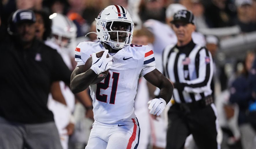 FILE - Arizona running back Ismail Mahdi (21) runs for a long gain in the second half of an NCAA college football game Saturday, Nov. 1, 2025, in Boulder, Colo. (AP Photo/David Zalubowski, File)