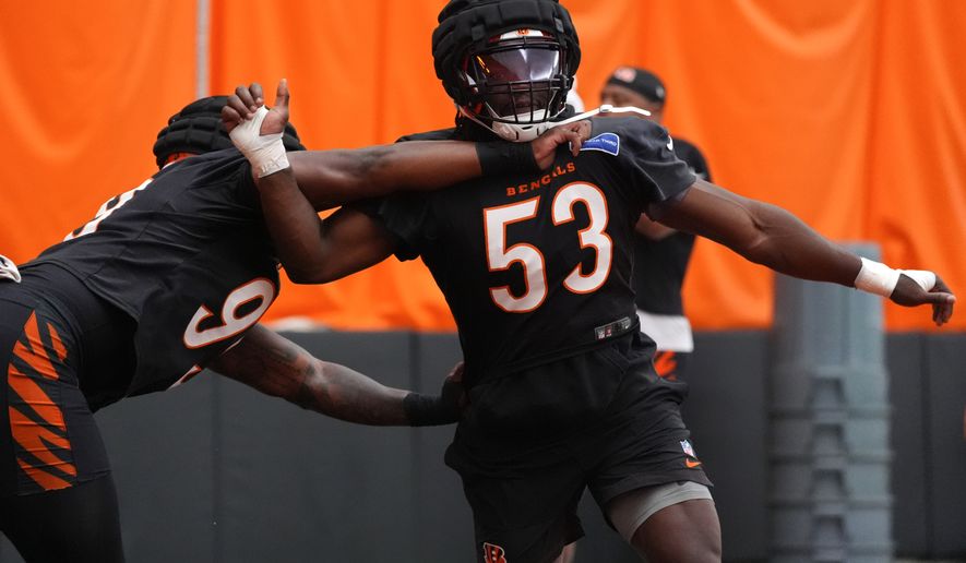 Cincinnati Bengals linebacker Boye Mafe (53) competes against defensive end Myles Murphy (99), left, during practice at the team's NFL football training camp, Saturday, Aug. 1, 2026, in Cincinnati. (AP Photo/Kareem Elgazzar)