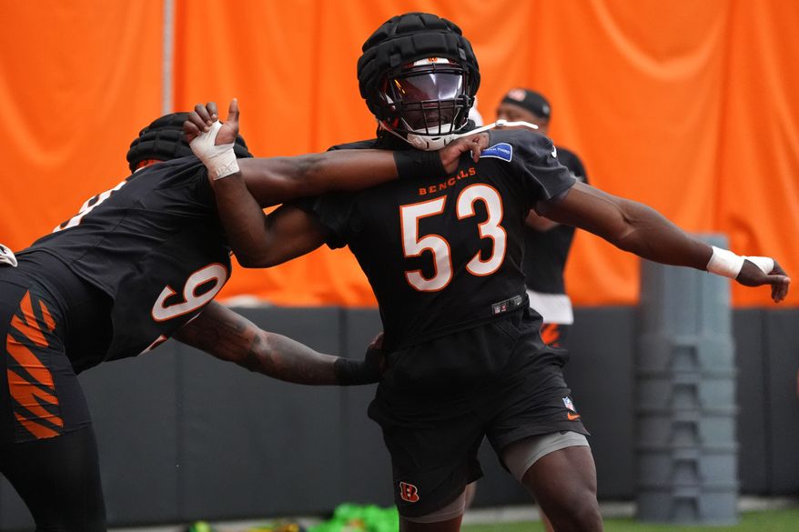 Cincinnati Bengals linebacker Boye Mafe (53) competes against defensive end Myles Murphy (99), left, during practice at the team's NFL football training camp, Saturday, Aug. 1, 2026, in Cincinnati. (AP Photo/Kareem Elgazzar)