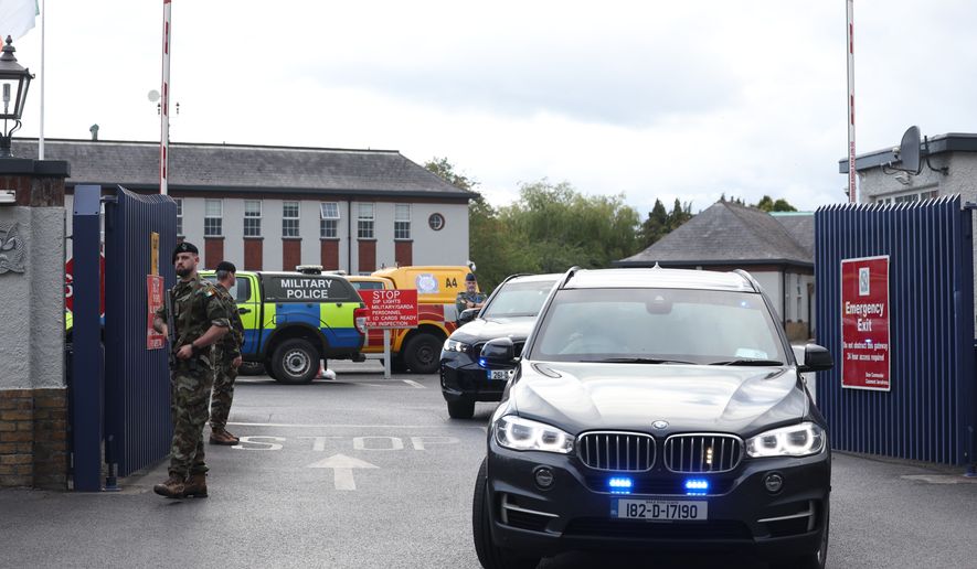 Garda vehicles leaving Casement Aerodrome, Baldonnell, Ireland, Sunday, Aug. 9, 2026, where a Irish government plane believed to be carrying Daniel Kinahan landed, following him being extradited from Dubai, to face a charge of directing an organized crime group. (Damien Eagers/PA via AP)