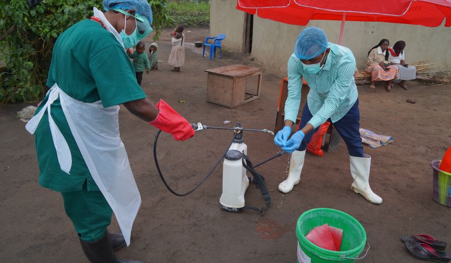 Wiza Bondele, Right, a health worker on the prevention and control team, seen at work in Ituri province, eastern Congo, Wednesday, Aug 5, 2026. (AP Photo/Dieudonne Dirole)