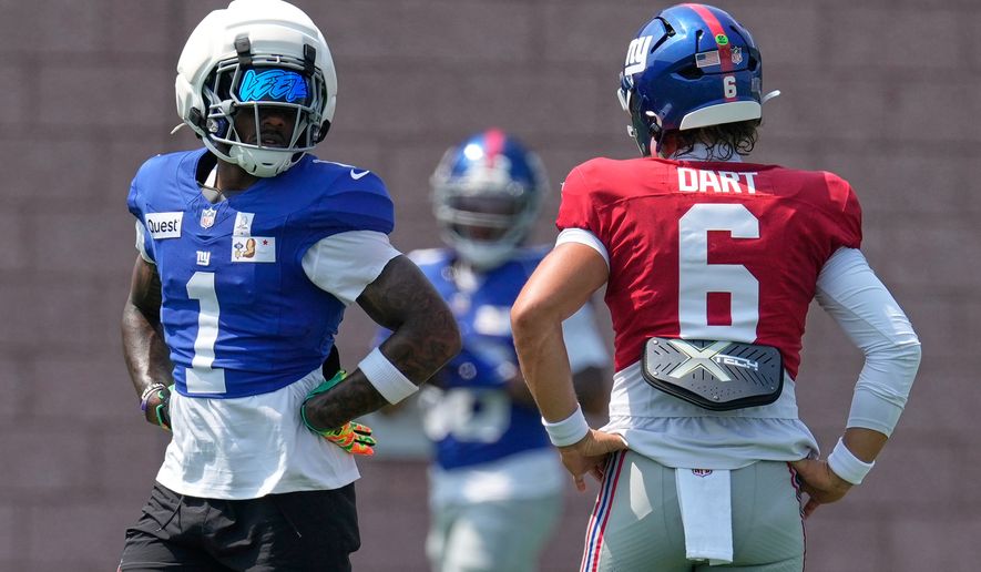 New York Giants' Malik Nabers, left, talks with quarterback Jaxson Dart (6) at the team's NFL football facilities in East Rutherford, N.J., Monday, Aug. 10, 2026. (AP Photo/Seth Wenig)