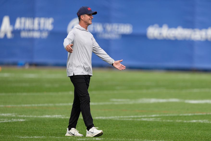 New York Giants head coach John Harbaugh greets people after a practice at the team's NFL football facilities in East Rutherford, N.J., Monday, Aug. 10, 2026. (AP Photo/Seth Wenig)