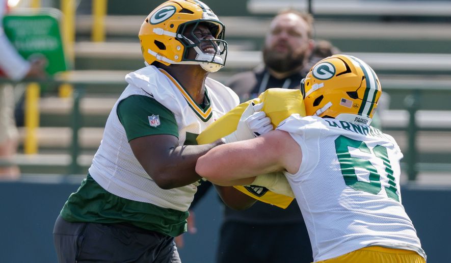 Green Bay Packers offensive tackle Anthony Belton (71) and guard Karsen Barnhart (61) run a drill during practice at the team's NFL football training camp, Thursday, July 30, 2026, in Green Bay, Wis. (AP Photo/Matt Ludtke)