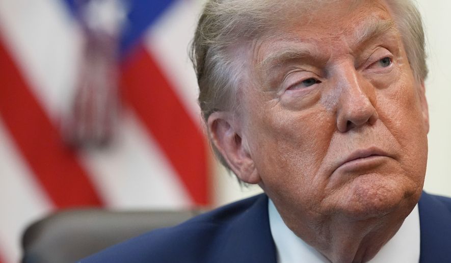 President Donald Trump listens during a meeting to sign an executive order about vaccines, Monday, Aug. 10, 2026, in the Oval Office of the White House in Washington. (AP Photo/Jacquelyn Martin)
