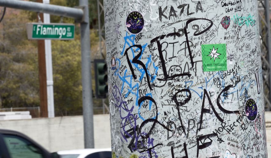 Graffiti about Tupac is seen on a pole Monday, Aug. 10, 2026, near the intersection where he was shot at in Las Vegas. (AP Photo/Ty ONeil)