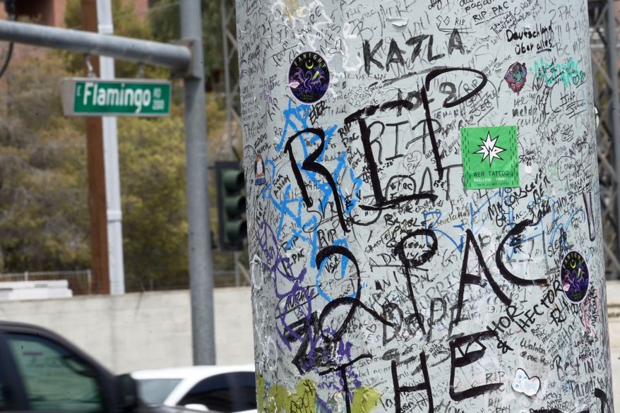 Graffiti about Tupac is seen on a pole Monday, Aug. 10, 2026, near the intersection where he was shot at in Las Vegas. (AP Photo/Ty ONeil)