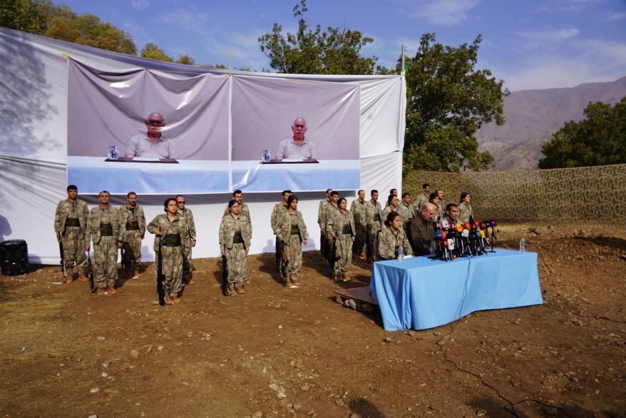 Kurdistan Workers' Party (PKK) fighters, who reportedly withdrew from Turkey with their weapons, stand to attention during a ceremony in the Qandil area of northern Iraq, щт Oct 26, 2025. (AP Photo/Rashid Yahya, File)