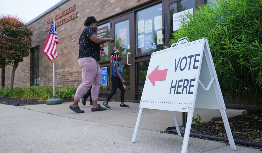 People enter a voting site on primary Election Day Tuesday, Aug. 11, 2026, in Minneapolis. (AP Photo/Ellen Schmidt)