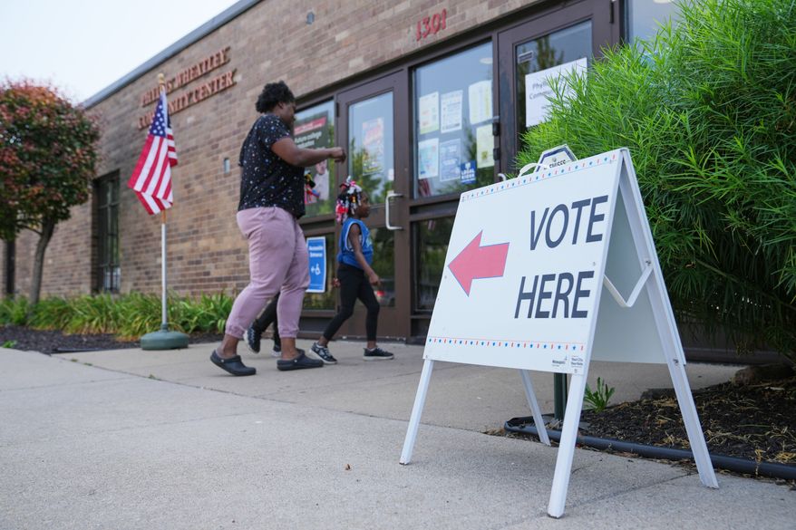 People enter a voting site on primary Election Day Tuesday, Aug. 11, 2026, in Minneapolis. (AP Photo/Ellen Schmidt)