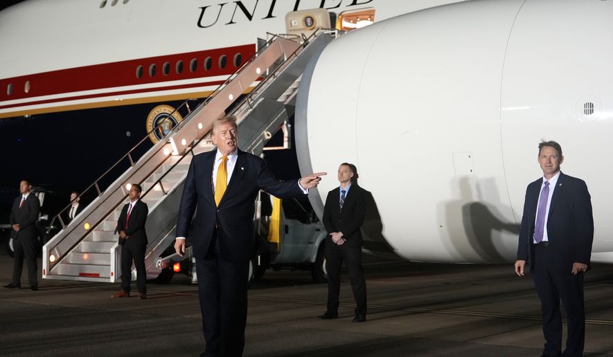 Surrounded by security, President Donald Trump switches planes at U.S. Air Force Base, RAF Mildenhall in Suffolk Eastern England, on his way back to Washington from the NATO summit in Ankara, Turkey, Wednesday, July 8, 2026. (AP Photo/Alex Brandon)