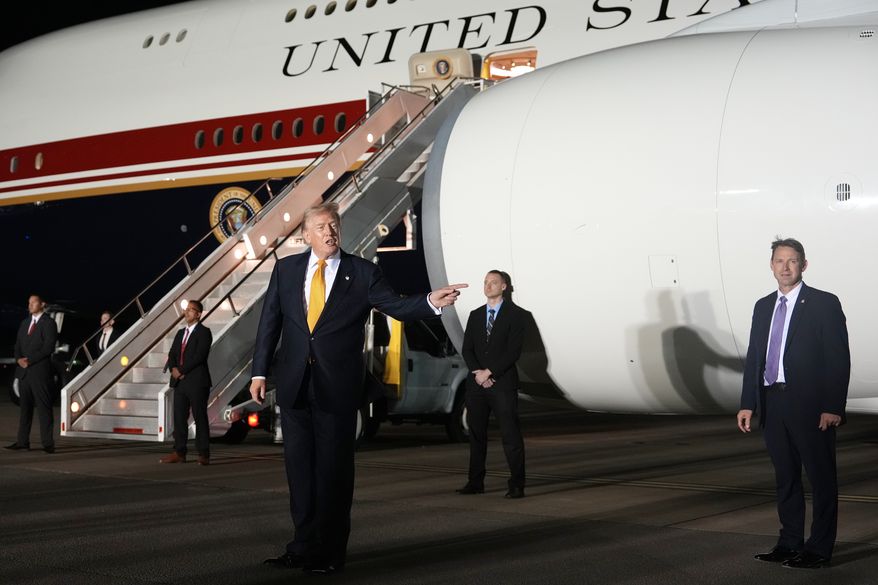 Surrounded by security, President Donald Trump switches planes at U.S. Air Force Base, RAF Mildenhall in Suffolk Eastern England, on his way back to Washington from the NATO summit in Ankara, Turkey, Wednesday, July 8, 2026. (AP Photo/Alex Brandon)
